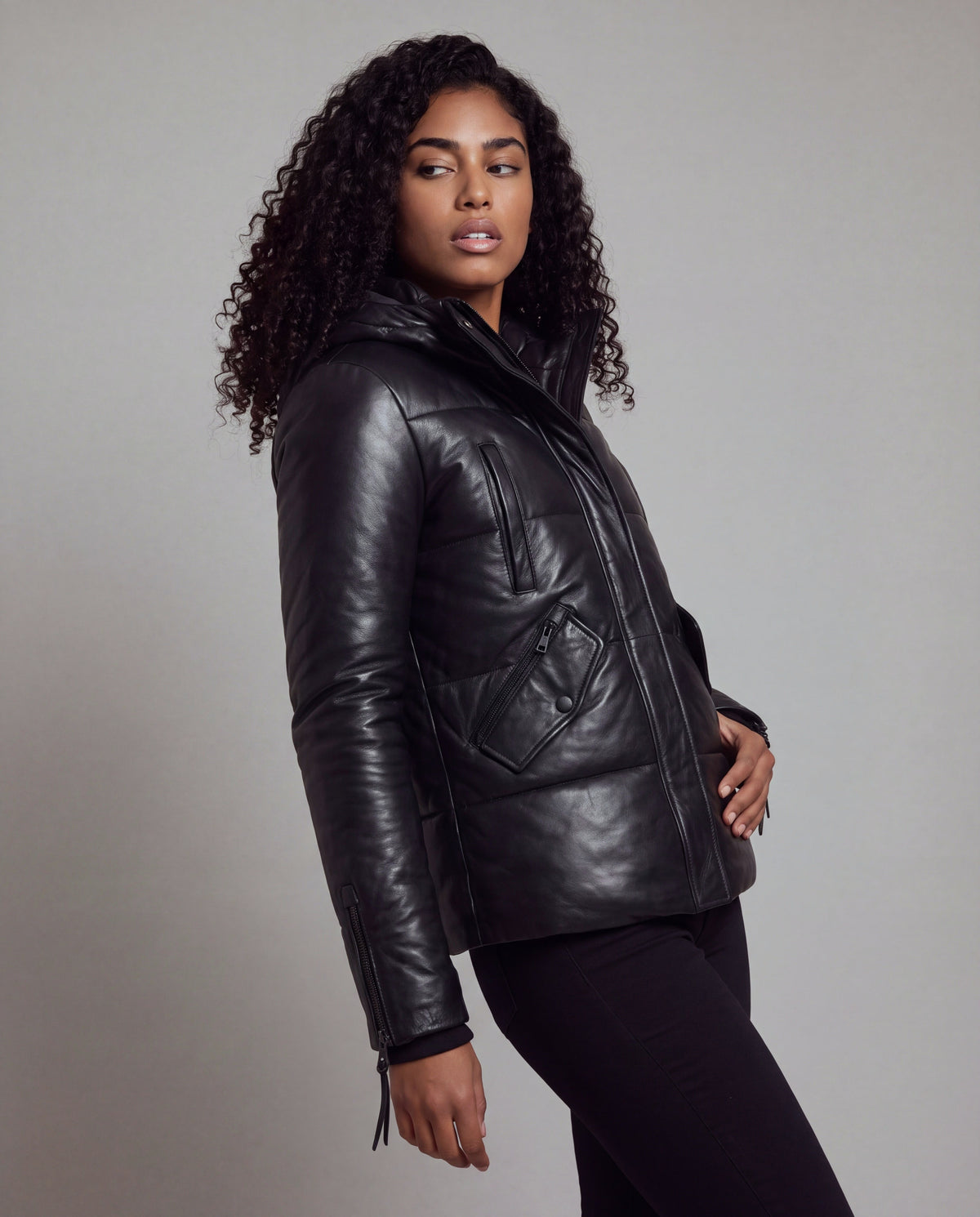 Cocoon by tigha – women's puffer leather jacket with hood in sheepskin, Heavy Washed Black, three-quarter view on model