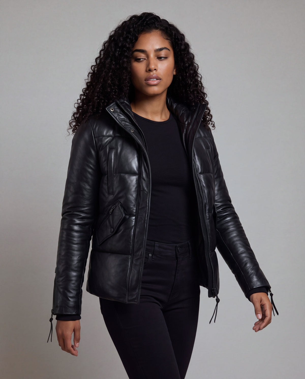 Cocoon by tigha – women's puffer leather jacket with hood in sheepskin, Heavy Washed Black, three-quarter view, worn open