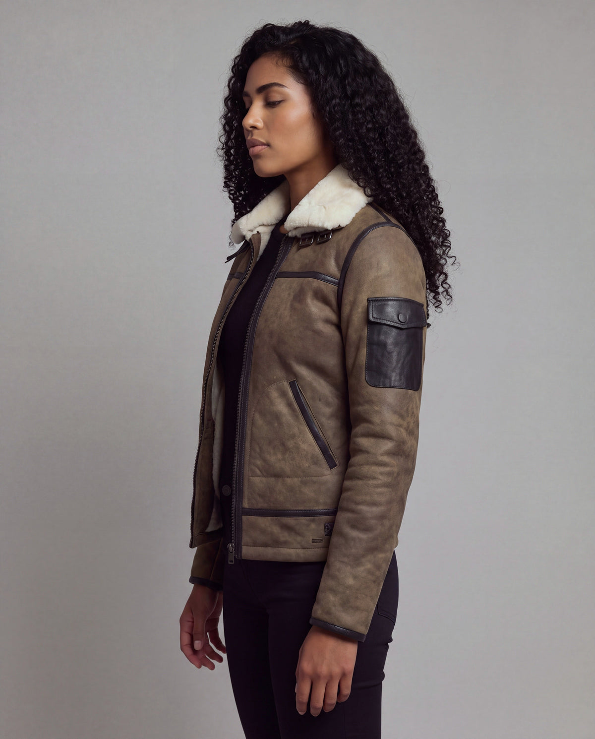 Forest von tigha – Aviator-Lederjacke mit doppeltem weißem Shearling-Kragen für Damen, olivbraunes Schafsleder in Elephant Vintage, Seitenansicht mit Ärmeltasche
