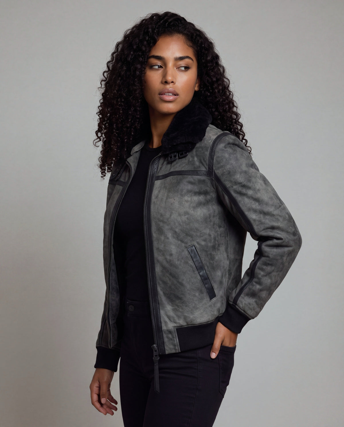 Talvi by tigha – women's leather aviator jacket with double shearling collar, sheepskin in Elephant Vintage Grey, three-quarter view, hand in pocket